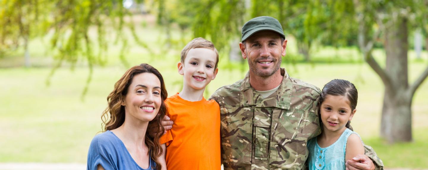veteran with wife and children outside